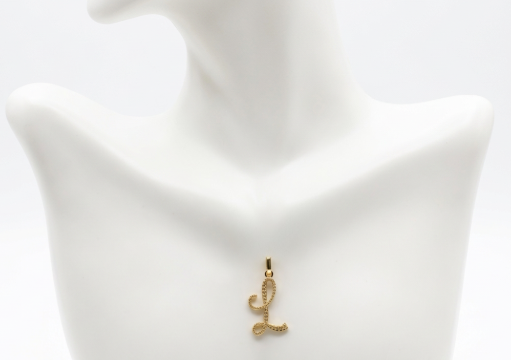 Gold letter 'L' pendant on a white bust