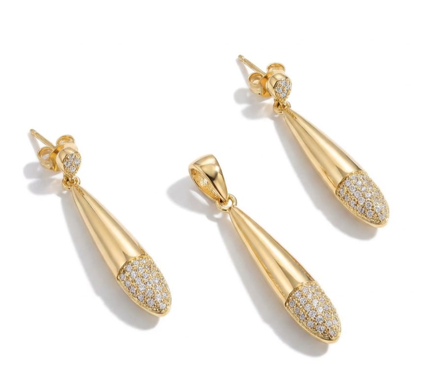 Gold teardrop earrings with diamond accents on a white background
