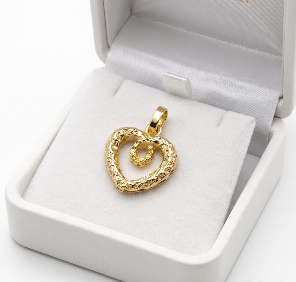 Gold heart-shaped pendant in a white jewelry box